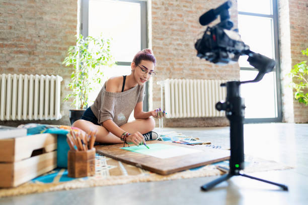 Beautiful female artist recording her video tutorial.